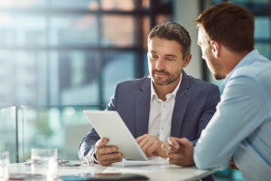 business meeting man holding tablet